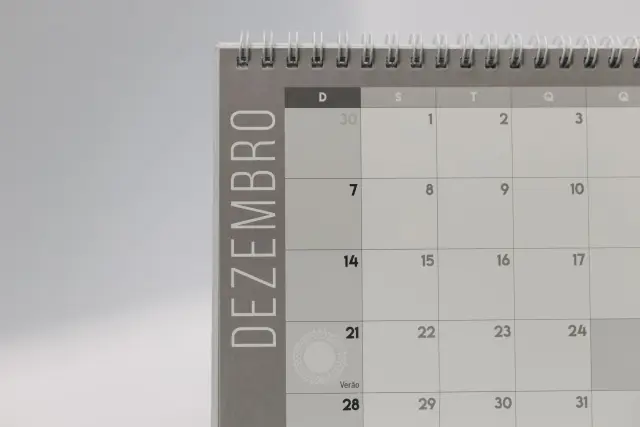 A simple December calendar page on a plain surface in flat daylight.