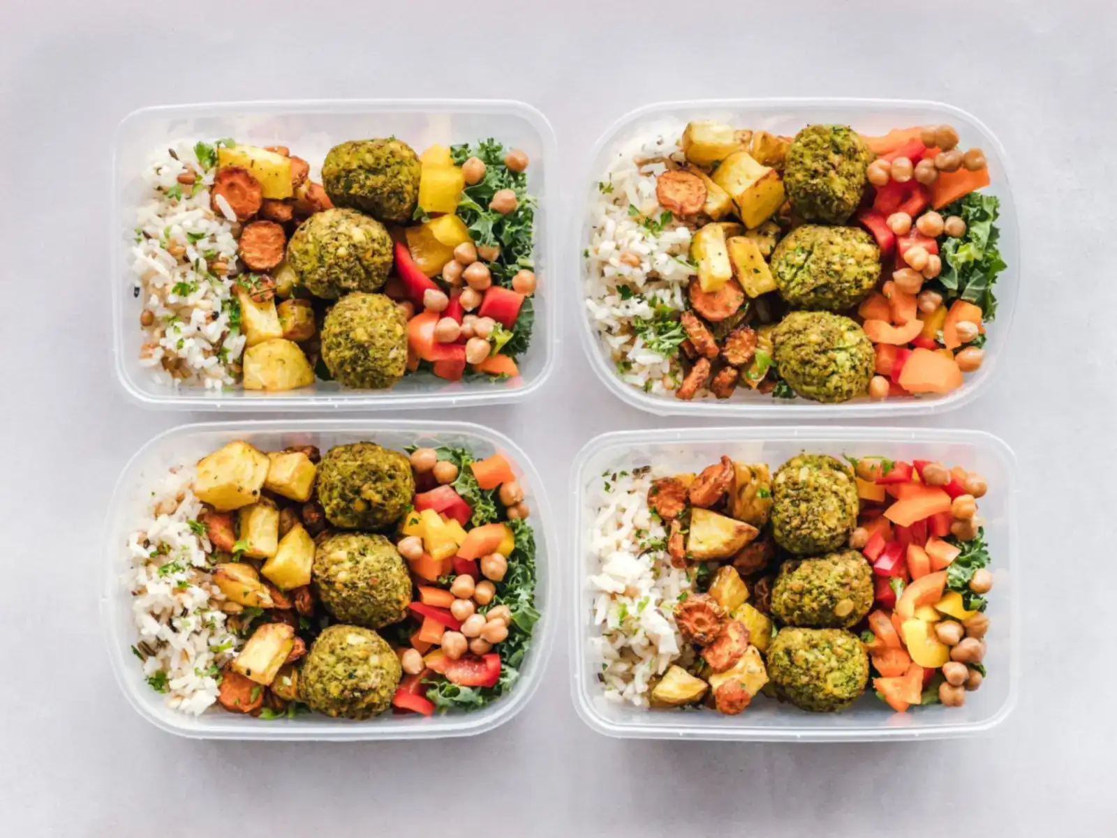 Meal-prep containers filled with grains, chickpeas, and vegetables lined up for the week, the kind of protein-forward planning that carries the first 90 days after stopping Ozempic.