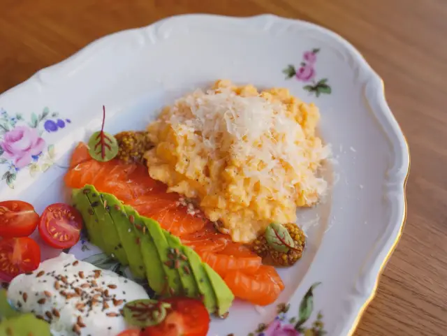 Eggs, smoked salmon, and avocado on a plate.