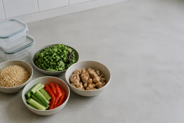 Ingredients for a simple prepared meal laid out on a plain kitchen counter in daylight.
